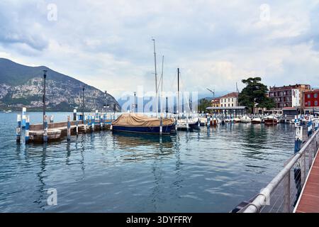 Small marina with sailboats and moored yachts on Lake Iseo in the town of Iseo, Lombardy, northern Italy Stock Photo