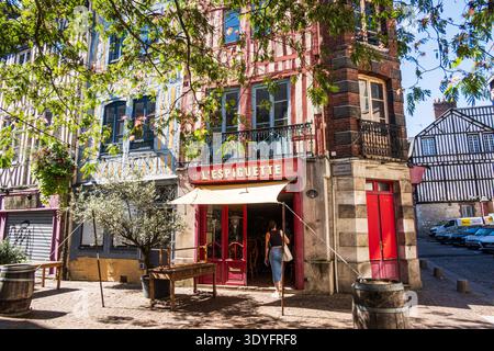 Rouen, Normandy, France - September 7, 2023: Woman entering a bar, a typical half-timbered house in downtown Rouen, place Saint-Amand. Stock Photo