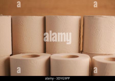 Rolled paper towels displayed on a wooden shelf Stock Photo