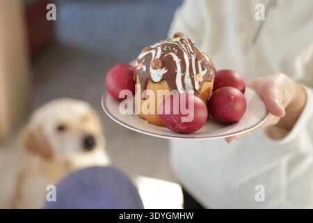 A festive Easter plate with a decorated cake topped with chocolate icing and sprinkles Stock Photo
