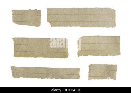 Torn pieces of old lined paper featuring rough edges and a textured, yellowish surface, creating a vintage note background. Isolated Stock Photo