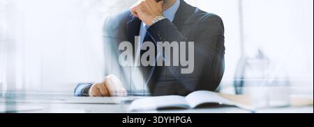 Middle Aged Entrepreneur Working in Office With Focus on Corporate Emails and News Updates Stock Photo