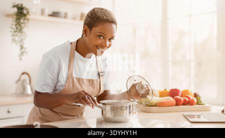 Cooking in a Bright Kitchen With Fresh Fruits and Vegetables on a Wooden Table Stock Photo
