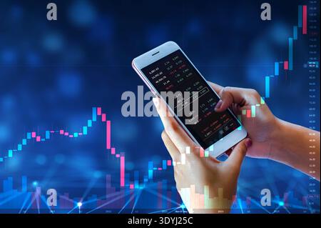 Business man trader investor analyst using mobile phone app analytics for cryptocurrency financial market analysis, trading data index chart graph on Stock Photo