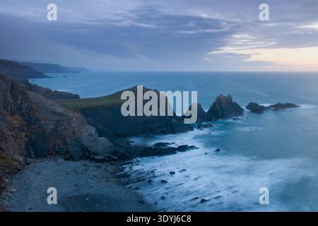 Storm light over Hartland Quay folded rock formations and Atlantic coastline, North Devon, England, United Kingdom. Stock Photo