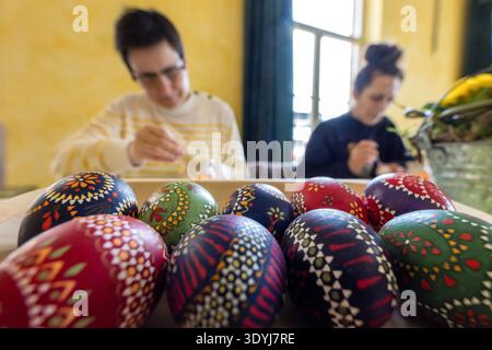 08 March 2026, Brandenburg, Lübbenau: Participants in the Easter workshop apply patterns to hen's eggs with wax. In small groups, people are familiarized with the wax batik or reserve technique at the Easter workshop. In this technique, wax is applied to the areas that are not to be dyed. After the egg has been dyed, the wax is removed again. Photo: Frank Hammerschmidt/dpa Stock Photo