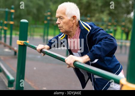 Senior european man doing push-ups outdoors Stock Photo