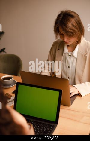 two women working with laptops in cafe or coworking space Stock Photo