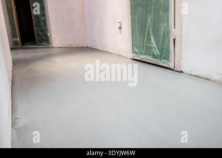 view of self-leveling floor in corridor during renovation of city apartment Stock Photo