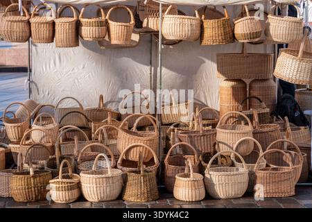 Group of empty wicker baskets in a tent or stall for sale in a street market or traditional fair in winter or spring Stock Photo