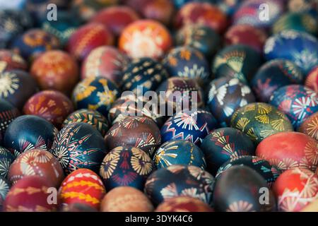 Traditional Lithuanian wooden colorful Easter eggs in a wicker basket, symbol of fertility and life painted with the symbols of nature Stock Photo