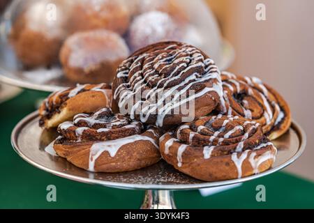 Close-up of a freshly baked cinnamon rolls with swirled layers of dough and cinnamon filling  on a tray Stock Photo