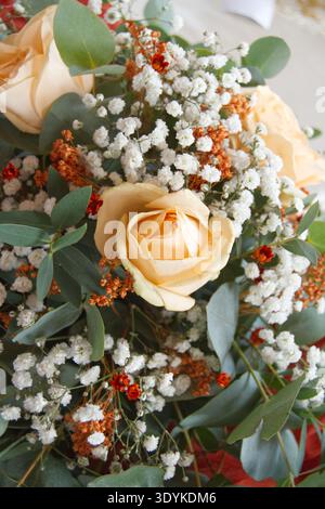 Elegant wedding table decoration with gold accents, eucalyptus greenery and terracotta details. Romantic tablescape for a modern boho wedding Stock Photo