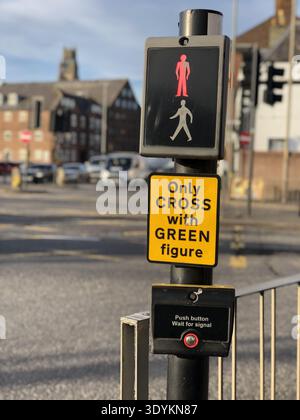 red stop sign on a UK pelican crossing with defocused urban road and town background Stock Photo