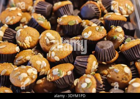 Mini banana muffins with seeds and nuts showing moist texture and healthy bakery snack concept with natural ingredients. Stock Photo