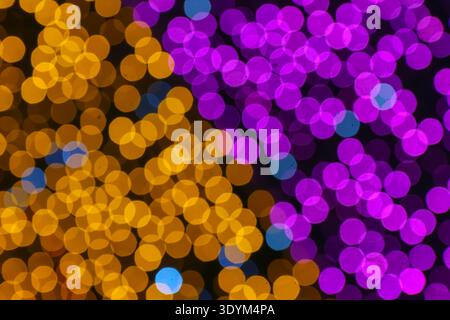 Purple and gold circular bokeh lights abstract background creating a festive luxury atmosphere with soft glowing effect. Stock Photo