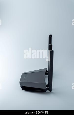 Wireless WiFi router with four antennas isolated on white background used for home or office internet network connection Stock Photo