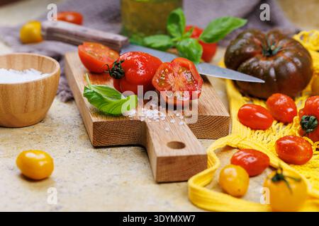 Yellow and red tomatoes in mesh bag on countertop Stock Photo