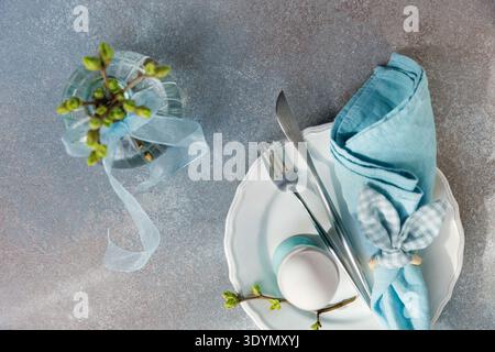 Easter Place Setting with Blue Linen and Buds Stock Photo