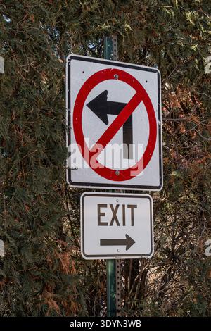 Vertical photo of road sign showing no left turn and exit to the right, traffic regulation and navigation concept Stock Photo