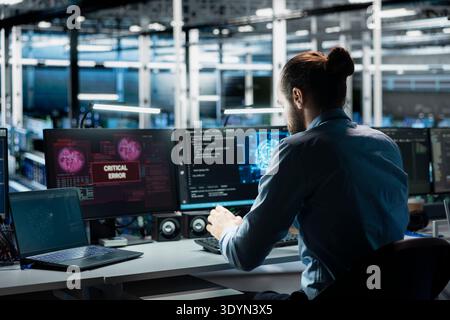 Data center computer scientist trying to fix malfunctions using AI program. Server hub IT professional using machine learning to optimize system health, repairing critical error Stock Photo