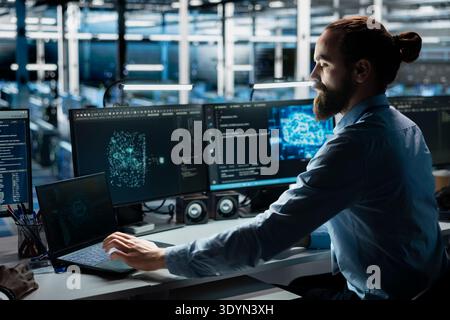 Data center system administrator running simulations for AI driven forecasting, tracking performance. Server farm IT worker integrating artificial intelligence APIs into software platforms Stock Photo