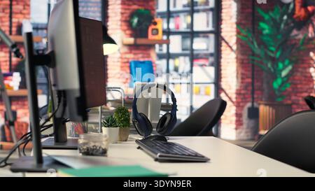 Empty office desk with computer screen showing terminal windows and network neurons. AI powered system uses cognitive computing and pattern recognition for futuristic software solutions. Stock Photo