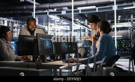 Data center admins working together, collaborating on neural network software development. Teamworking server hub colleagues implementing artificial intelligence technology in workplace, camera A Stock Photo