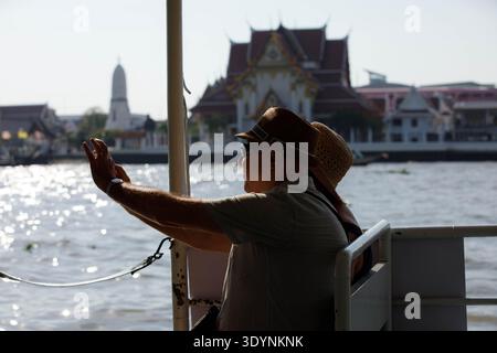 BANGKOK, THAILAND-FEB 7, 2026: Senior couple sitting on Chao Phraya crossing boat, travelers discovering a new destination, side profile Stock Photo