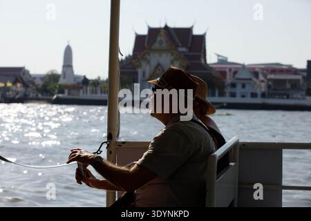 BANGKOK, THAILAND-FEB 7, 2026: Senior couple sitting on Chao Phraya crossing boat, travelers discovering a new destination, side profile Stock Photo