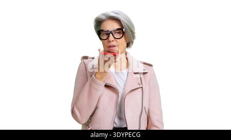 Senior woman recording voice message on red smartphone Stock Photo