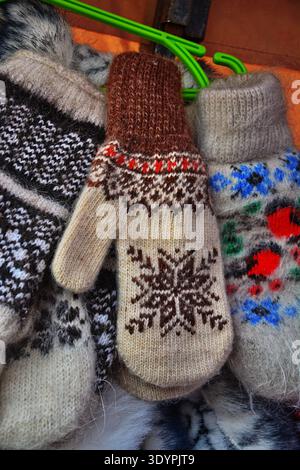 colorful wool mittens. knitted mittens on winter background. Winter season symbol. Stock Photo
