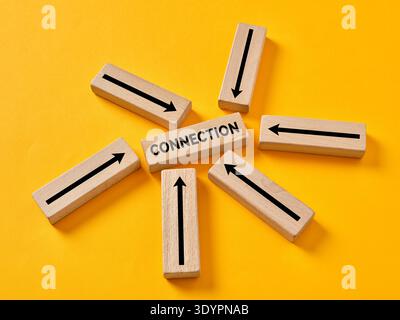 Wood blocks forming a central point, emphasizing collaboration, networking, and data flow in a business communication concept Stock Photo
