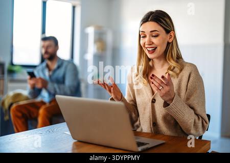 Man and woman working remotely using laptop. Male female freelancers working together. Digital nomad Stock Photo