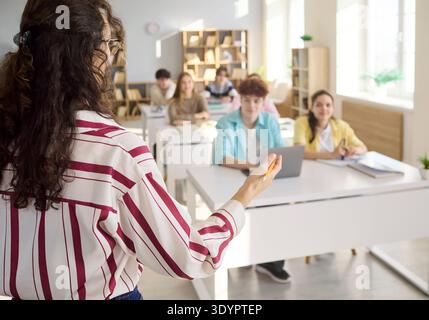 Teacher addressing students during classroom lesson and group discussion Stock Photo