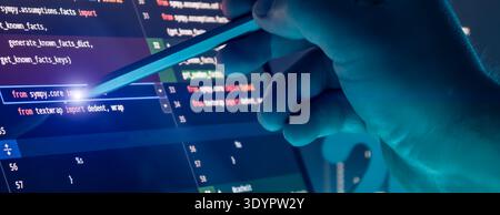 Close Up of Programmer Hand Using Stylus on Source Code Editor Screen in Futuristic Blue Tech Stock Photo