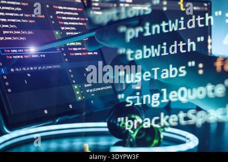 Programmer Using Stylus on Coding Screen with Abstract Code Overlay in Futuristic AI Development Stock Photo