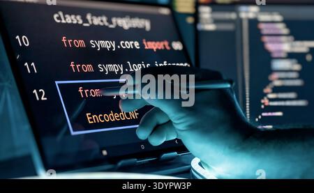 Programmer Editing Source Code with Stylus on Touchscreen in Futuristic Software Development Stock Photo