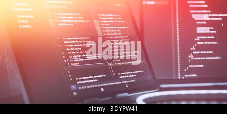 Futuristic Software Coding Workspace with Warm Gradient Light Overlay and Source Code Stock Photo