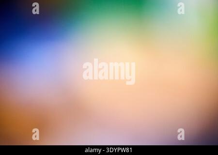A vibrant and smooth abstract background featuring a soft gradient blend of warm peach, orange, and brown tones transitioning into a gentle blue and s Stock Photo