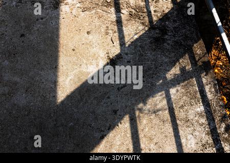 Sunlight Casting Shadow On Concrete Floor Surface, A striking photo of sunlight casting dramatic shadows on a concrete floor, capturing bold geometric Stock Photo
