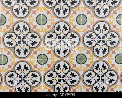 Intricate Vintage Peranakan Floral Floor Tile Pattern with Symmetrical Geometric Mandalas in Green, Yellow, and Black Stock Photo