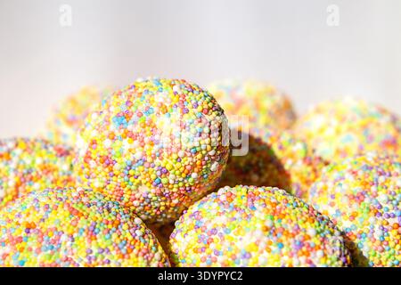 Colorful tactile Easter eggs sprinkled with sprinkles for a festive dessert and sweet celebration. copyspace Stock Photo