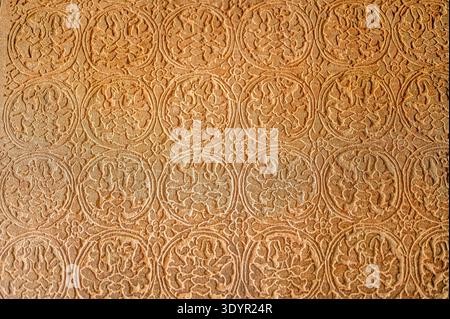 Abstract stone carving geometric floral pattern ancient temple wall texture bas relief detailed craft historic art background design architecture reli Stock Photo
