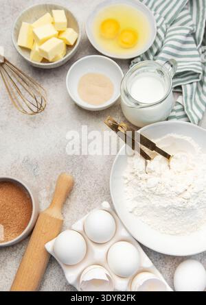 Assorted fresh ingredients for baking dough on a light kitchen counter background Stock Photo