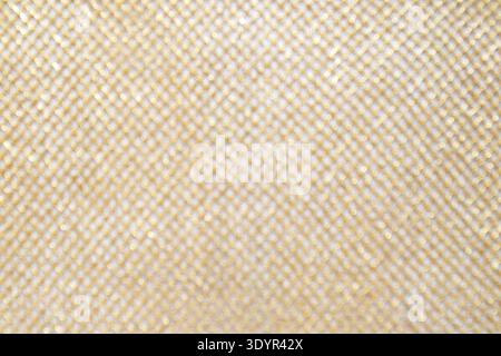 Soft gold mesh texture with glitter bokeh background and woven fabric pattern, close-up Stock Photo