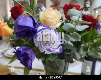 Colorful flower bouquet showcasing fresh eustoma and roses with eucalyptus foliage, creating a beautiful centerpiece for celebrating special occasions Stock Photo