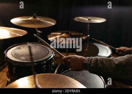 Close-up of drummer’s hands during rehearsal. Stock Photo