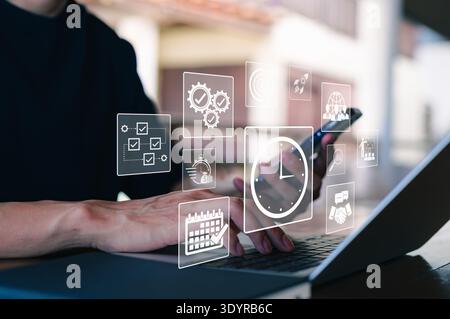 Time Management and Productivity Optimization Concept. Business professional using laptop with digital icons representing time tracking, productivity, Stock Photo
