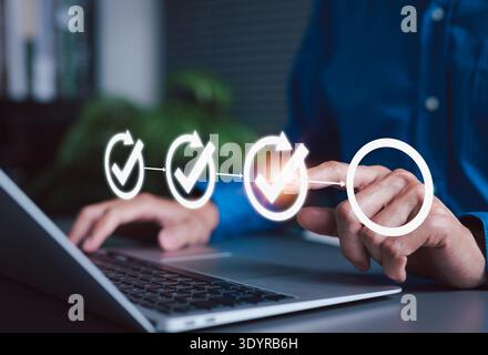 Project planning and workflow management concept Person using laptop with virtual checklist and progress icon, representing task tracking, business Stock Photo